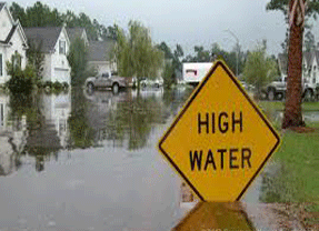 Flooded street with high water signage